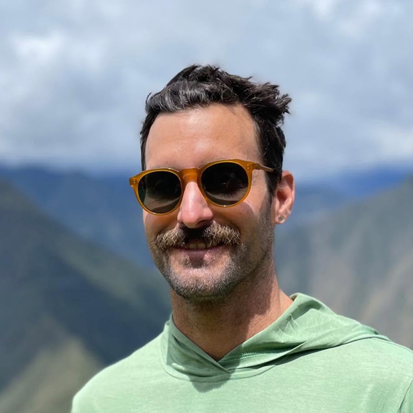 Portrait of Jesse O'Chapo wearing yellow sunglasses and a green hoodie